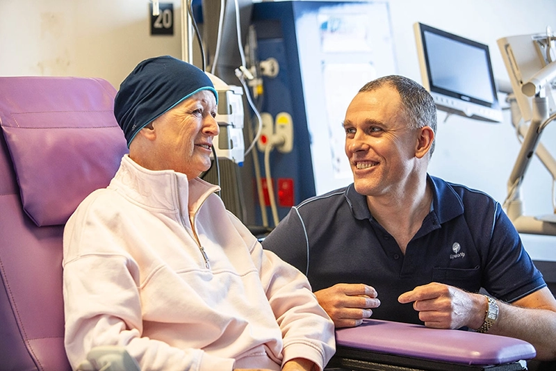 patient and staff smiling together 