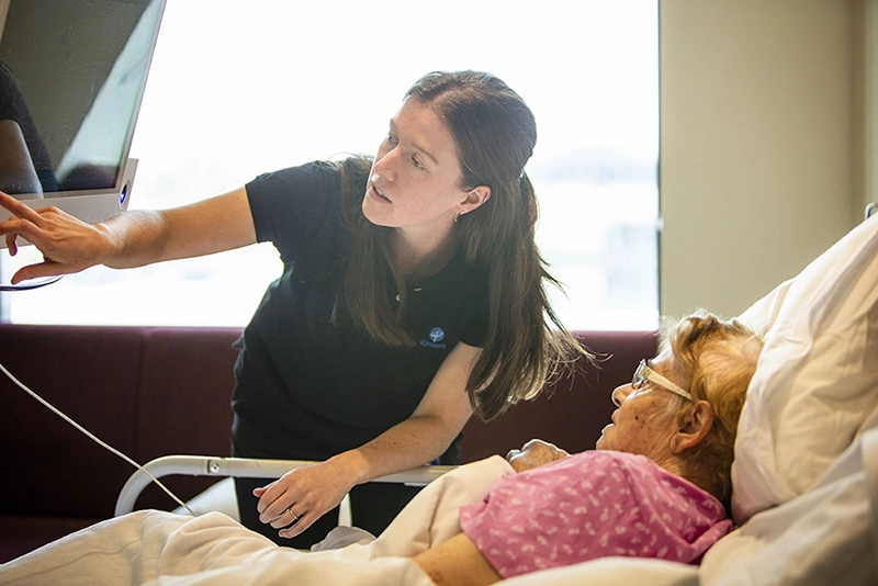 patient and Epworth staff looking at a screen together